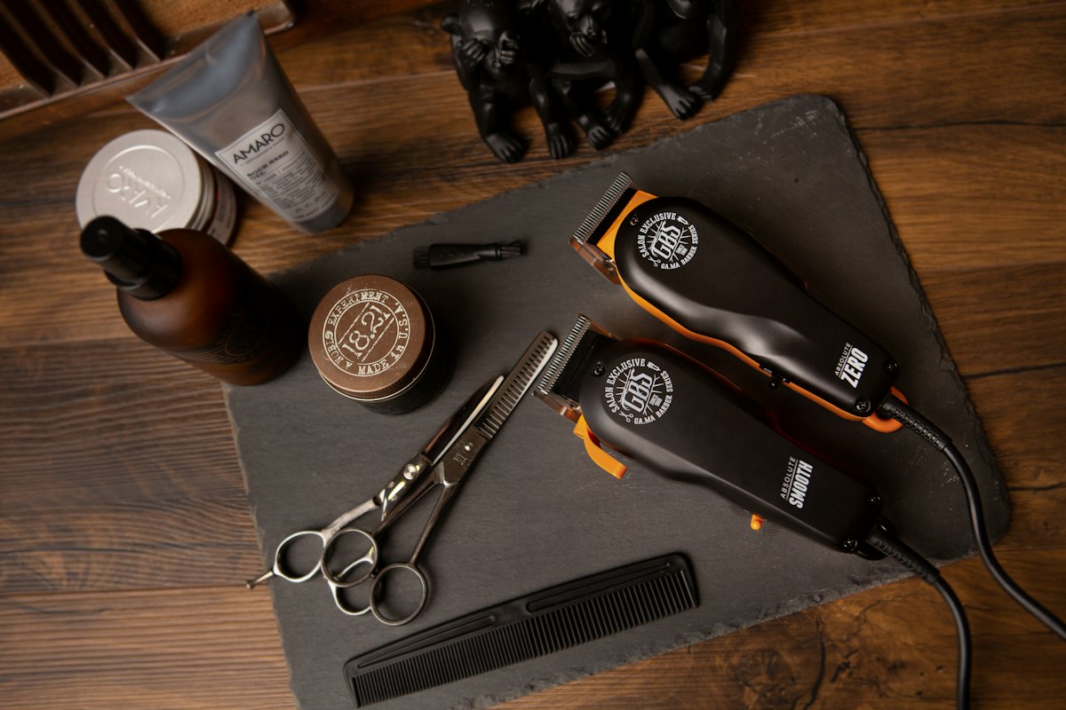 Illustrative barbering tools including clippers, scissors and combs on a wooden counter; not Shane's premises